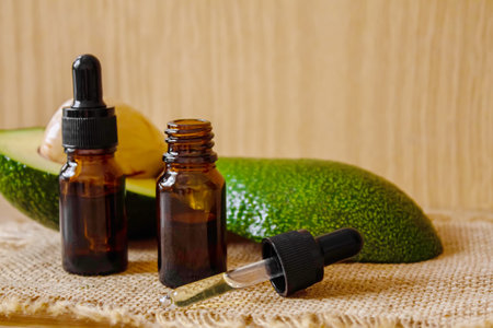 Avocado and avocado oil on wooden background. selective focus foodの写真素材