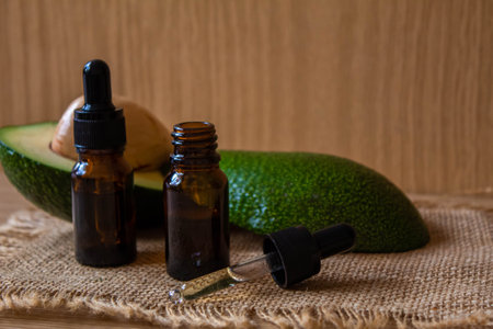 Avocado and avocado oil on wooden background. selective focus foodの写真素材