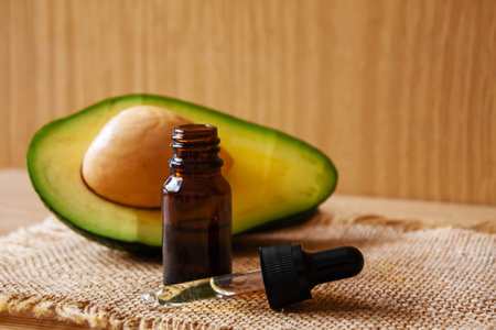 Avocado and avocado oil on wooden background. selective focus foodの写真素材