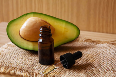Avocado and avocado oil on wooden background. selective focus foodの写真素材