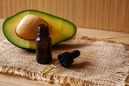 Avocado and avocado oil on wooden background. selective focus foodの写真素材