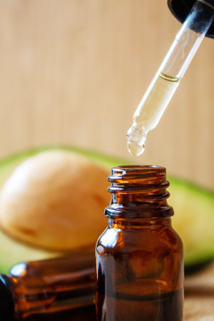 Avocado and avocado oil on wooden background. selective focus foodの写真素材