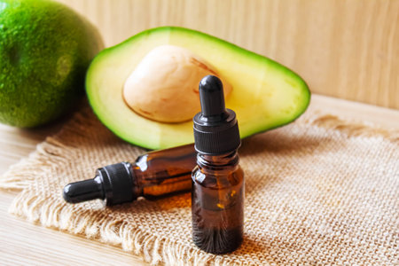 Avocado and avocado oil on wooden background. selective focus foodの写真素材