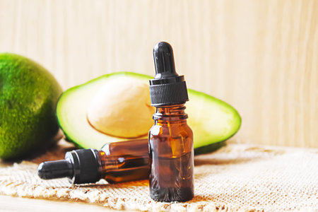 Avocado and avocado oil on wooden background. selective focus foodの写真素材