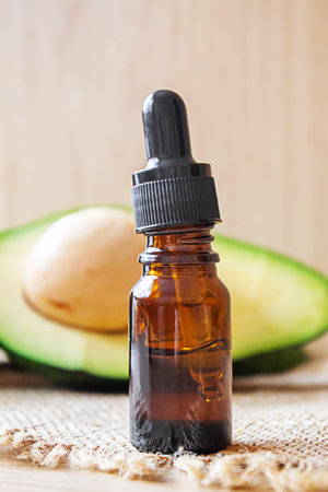 Avocado and avocado oil on wooden background. selective focus foodの写真素材