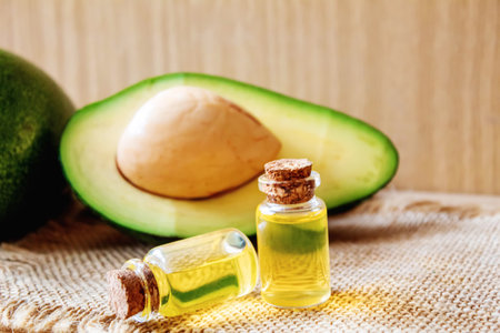 Avocado and avocado oil on wooden background. selective focus foodの写真素材