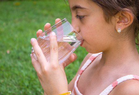 The child drinks water. selective focus. childrenの写真素材