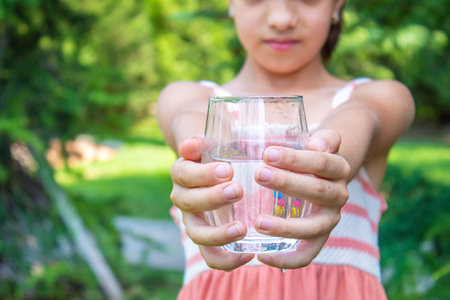 The child drinks water. selective focus. childrenの写真素材