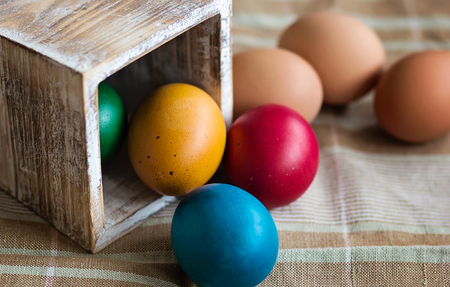Painted Easter eggs in a wooden boxの写真素材