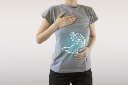 Digital composite of highlighted healthy stomach of woman / healthcare and medicine conceptsの写真素材