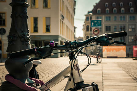 18 May 2019 Dresden, Germany / Travel concept photo of rental bikes at Neustadt Square in Dresden. Closeup sharp details of bike and atmospheric bokeh of classic 18th century architecture.のeditorial素材