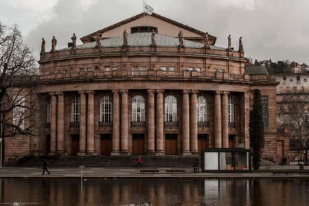 March 07, 2020 Stuttgart, Germany - Front view of famous historic Stuttgart Opera house designed by architect Max Littmann with small lake Eckensee in foreground on cloudy day in springtime.のeditorial素材