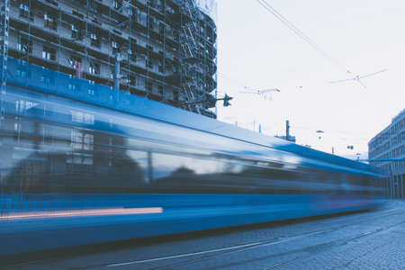 17 May 2019 Dresden, Germany - Public transportation in Dresden. Tram leaving the station, traffic lights, street, rails. Lights in night, long exposure.のeditorial素材