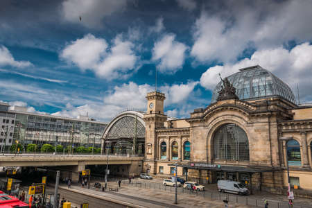 21 May 2019 Dresden, Germany - Dresden Hauptbahnhof - the main railway station. Street trams and train railways at bridge. Variety of Dresden public transportのeditorial素材