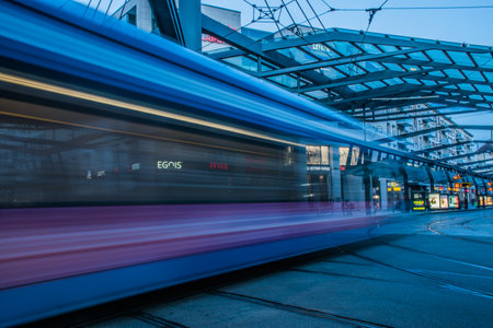 17 May 2019 Dresden, Germany - Public transportation in Dresden. Tram leaving the station, traffic lights, street, rails. Lights in night, long exposure.のeditorial素材