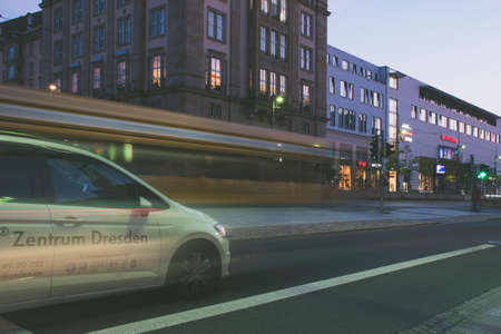 17 May 2019 Dresden, Germany - Public transportation in Dresden. Tram leaving the station, traffic lights, street, rails. Lights in night, long exposure.のeditorial素材
