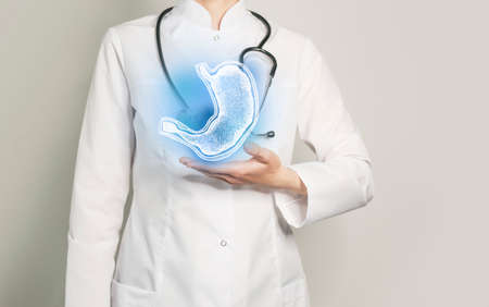 Stomach issues medical concept. Photo of female doctor, empty space.の写真素材
