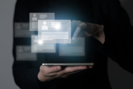 Managers`s hand pointing on highlighted cv cards with candidates information. Human resources concept.Illustrative material for articles and web.の写真素材