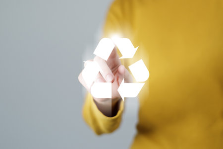Woman pushing abstract recycle sign. Global ecological responsibility and clean future concept.の写真素材