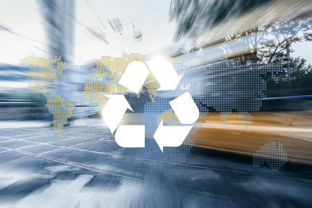 Big city road and tram way, recycle symbol and planet continents on bokeh background. Clean future and recycle concept.の写真素材