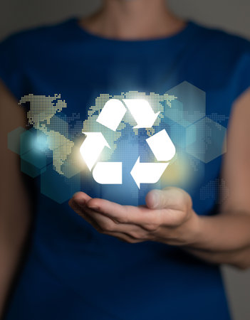 Woman holding abstract recycle sign. Global ecological responsibility and clean future concept.の写真素材