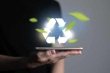 Hand holding recycle symbol on a screen of mobile phone. Mobile applications as asource of information about recycle and sustainability.の写真素材