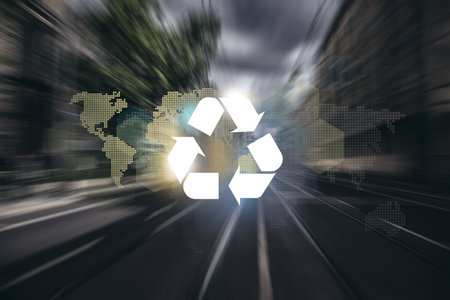 Big city road and tram way, recycle symbol and planet continents on bokeh background. Clean future and recycle concept.の写真素材