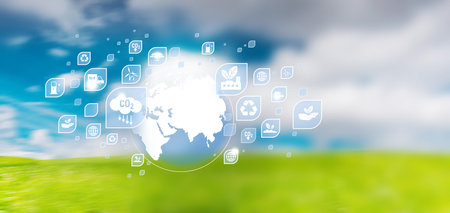 ESG icon concept. Globe illustration with icons. Motion blur of green field and sunny blue sky.の写真素材
