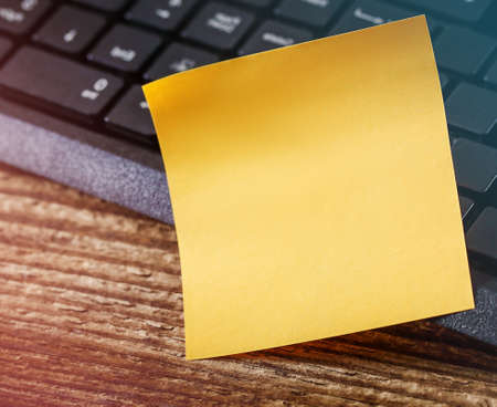 yellow sticker next to the computer keyboard, there is a place for text