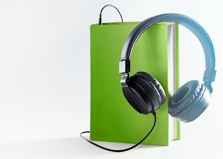 Audiobook concept. Headphones and books on the table. Side view with space for your textの写真素材