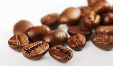 coffee beans scattered on a light backgroundの写真素材