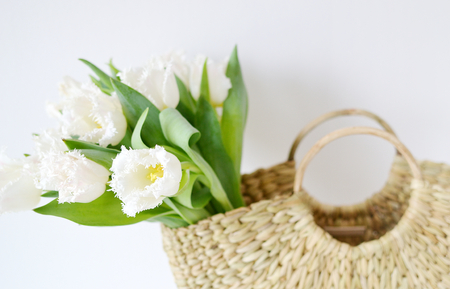 Wicker Handbag with Flowers Tulips, Spring Time, Summer Concept, White Background, Copy Spaceの写真素材