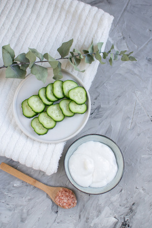 Cosmetic cream, face mask, scrub, cucumber, white bath towel, beauty conceptの写真素材