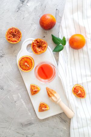 Fresh Red Orange Juice in the Glass Summer Morning Drink Beverage Wooden Hand Juicerの写真素材