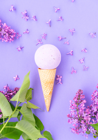 Composition of ice cream on a violet background Bathroom cosmetic accessories. Flat Lay. Top View. Lilac flowersの写真素材