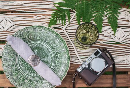 Wedding reception table with macrame tablecloth, decoration on a rustic wooden tableの写真素材