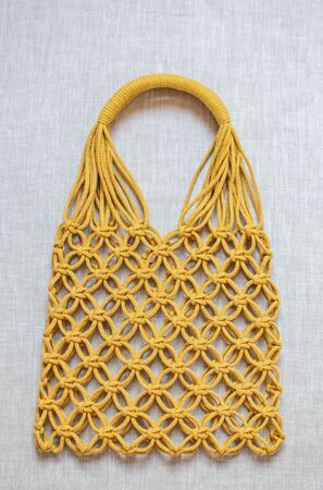 Handmade macrame shopping bag on the background, ECO friendly. Embroidery. Modern summer conceptの写真素材