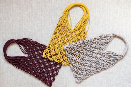 Handmade macrame shopping bags on the light background, ECO friendly