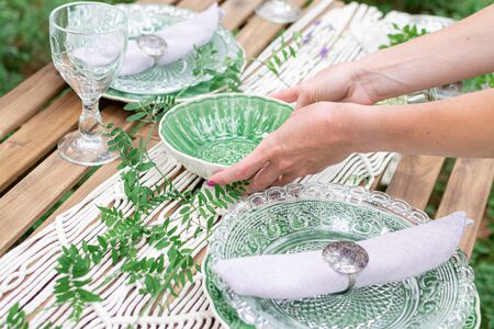 Wedding reception table with macrame tablecloth, decoration on a rustic wooden tableの写真素材