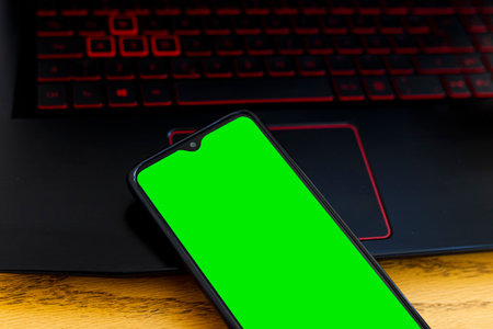 Smartphone with computer on wood deskの写真素材