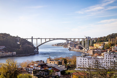 Porto, Portugal - NOVEMBER 05, 2019: Top view of buildings with red roofs in the city center of Porto, photo taken at the clÃ©rigos church, with sunbeamのeditorial素材