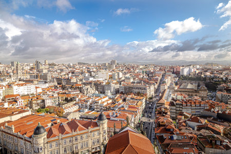 Porto, Portugal - NOVEMBER 05, 2019: Top view of buildings with red roofs in the city center of Porto, photo taken at the clÃ©rigos church, with sunbeamのeditorial素材