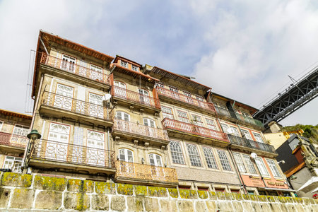 Porto, Portugal - NOVEMBER 05, 2019: Top view of buildings with red roofs in the city center of Porto, photo taken at the clÃ©rigos church, with sunbeamのeditorial素材