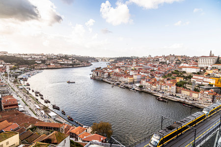 Porto, Portugal - NOVEMBER 05, 2019: Top view of buildings with red roofs in the city center of Porto, photo taken at the clÃ©rigos church, with sunbeamのeditorial素材