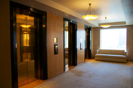 SINGAPORE - JULY 23rd, 2016: Three elevators in a luxury Hotel lobby with an awesome view of the...