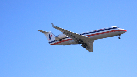 LOS ANGELES, CALIFORNIA, USA - OCT 9th, 2014: airplane shown shortly before landing at the LA Airport LAX.のeditorial素材