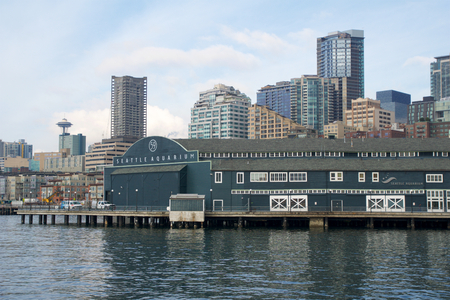 SEATTLE, WASHINGTON, USA - JAN 25th, 2017: A view on Seattle downtown from the waters of Puget Sound. Piers, skyscrapers, Space Needle and Seattle Aquarium in the city before sunsetのeditorial素材