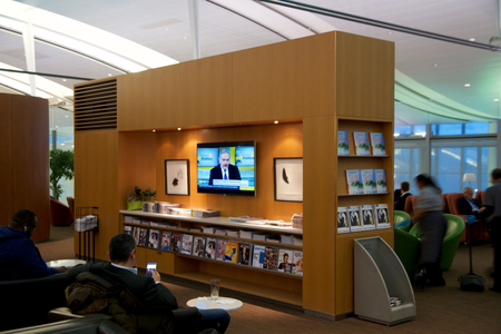 TORONTO, CANADA - JAN 28th, 2017: Air Canada Maple Leaf Lounge at YYZ airport International, seating area with colored leather chairs and newspapers and a TV, airport interior for frequent flyer.のeditorial素材