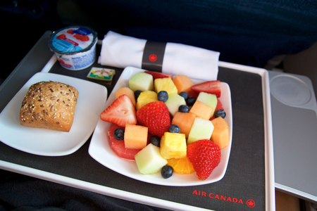 TORONTO, CANADA - JAN 27th, 2017: Air Canada Business Class in-flight meal, breakfast with fresh cutted fruits, coffee, yogurt and a bunのeditorial素材