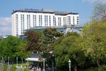 VIENNA, AUSTRIA - APR 30th, 2017: Outside view of the Hilton Vienna Hotel in Wien during nice weather with blue sky, five Star Hotel Hilton Near the green City Parkのeditorial素材